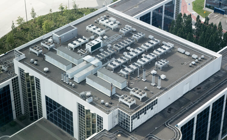 Small commercial HVAC system on a roof of an office building