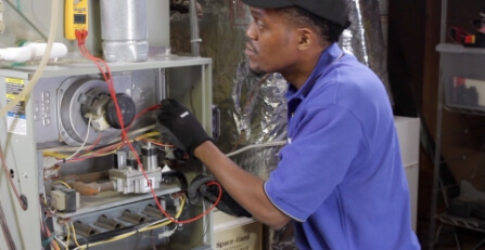 Technician repairing a furnace.