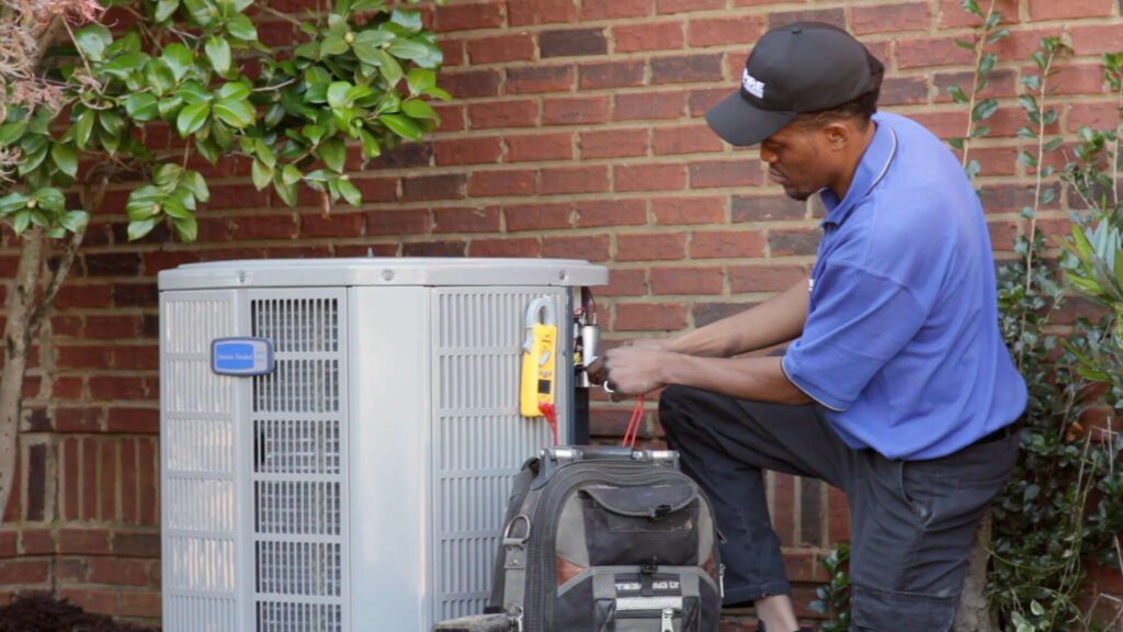 Empire employee working on outdoor AC unit