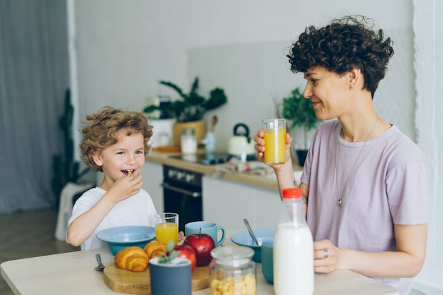 mother and child enjoy breakfast at table