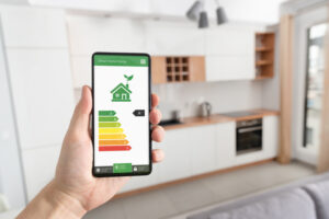 Energy efficiency mobile app on screen, eco house