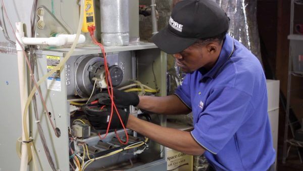 HVAC technician servicing a furnace.