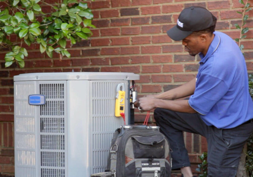 tech working on AC unit