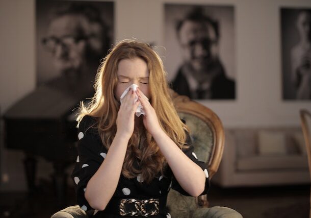 woman sneezing from seasonal allergies