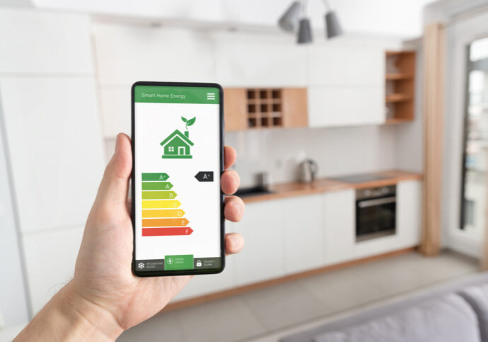 Energy efficiency mobile app on screen, eco house